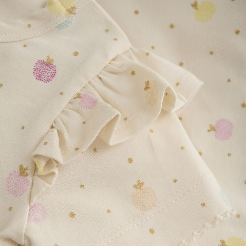 Nahaufnahme des Apfel-Prints auf dem Minymo Body, mit Druckknöpfen für leichtes An- und Ausziehen.