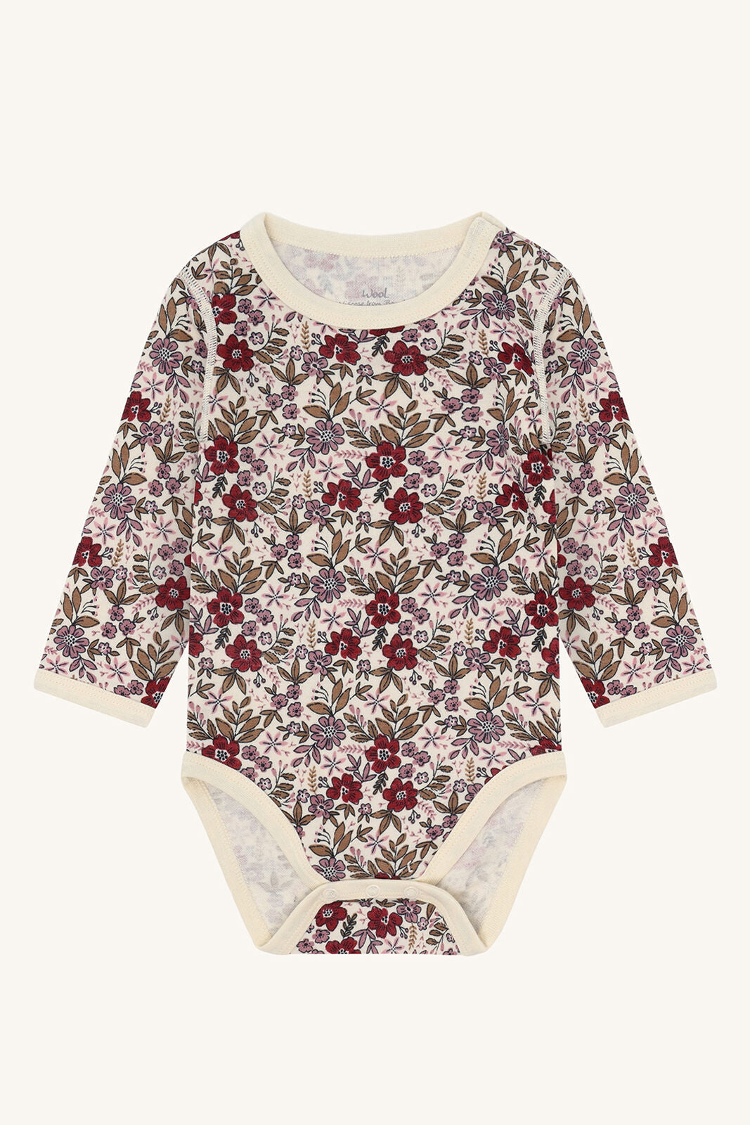 Vorderansicht Hust&Claire Baloo Body aus Wolle/Bambus mit Blumenmuster – erhältlich im Bärechind Winterthur, Zürich, Schweiz.