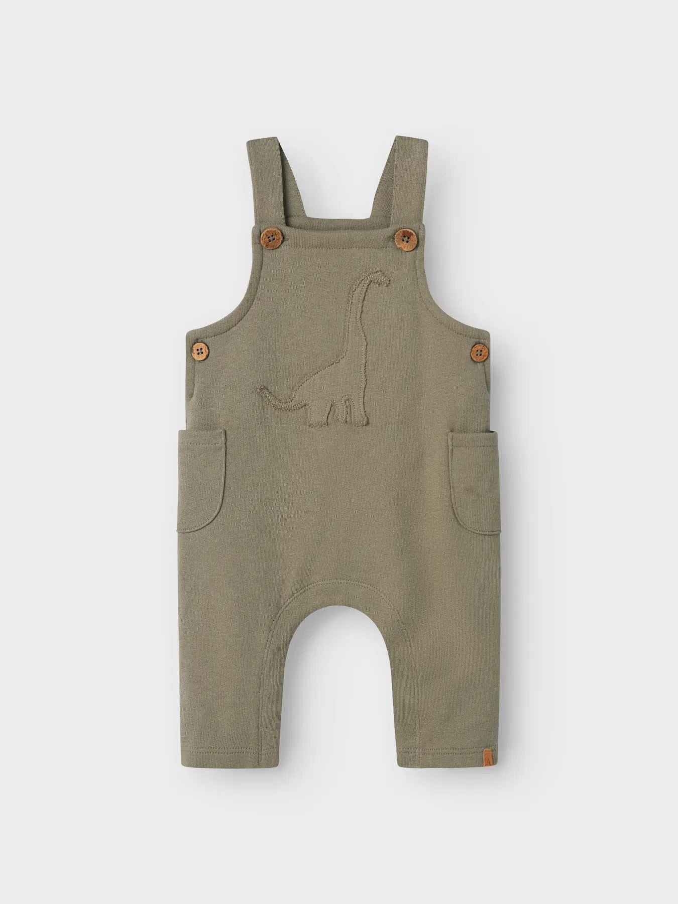 Latzhose von Lil' Atelier mit Dino-Stickerei aus Bio-Baumwolle – erhältlich bei Bärechind Winterthur.