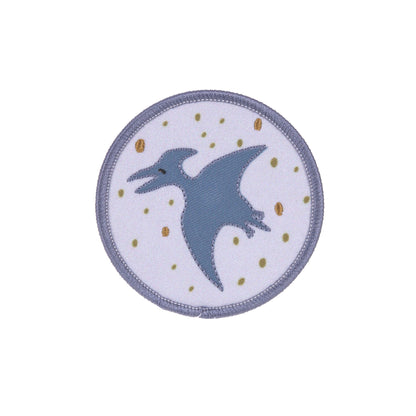 Runde Patch mit fliegendem Dinosaurier auf violettem Hintergrund aus dem Laessig Dinosaurier Set.