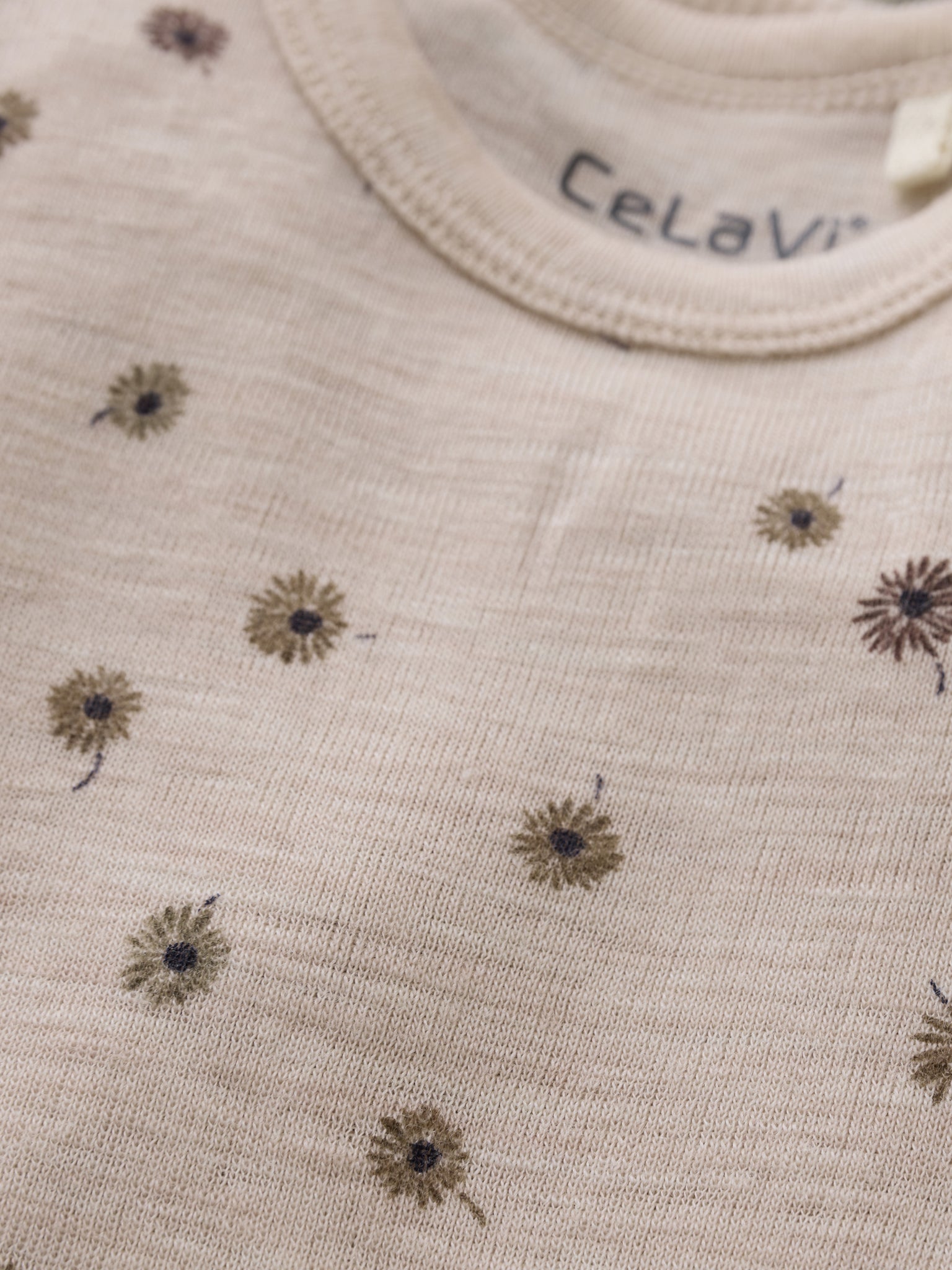 Detailansicht des CeLaVi Wollbodys mit Blumenmuster, erhältlich im Bärechind in Winterthur, Zürich Schweiz.