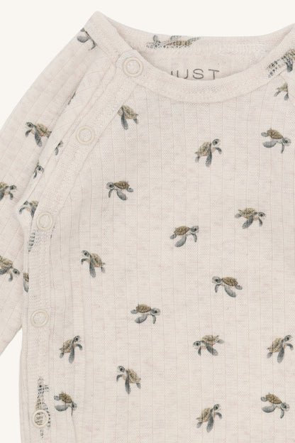 Detailaufnahme des Schildkrötenprints auf dem Hust&Claire Bing Wickelbody aus GOTS Baumwolle, Bärechind Winterthur Zürich Schweiz.