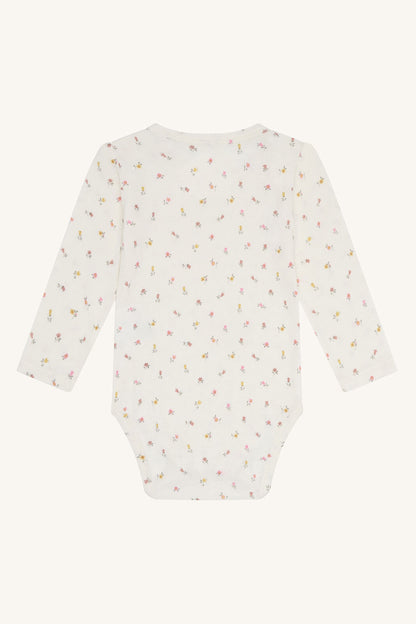 Rückansicht des Hust & Claire Buller Bambus Bodys mit Blumenprint bei Bärechind in Winterthur, Zürich, Schweiz.