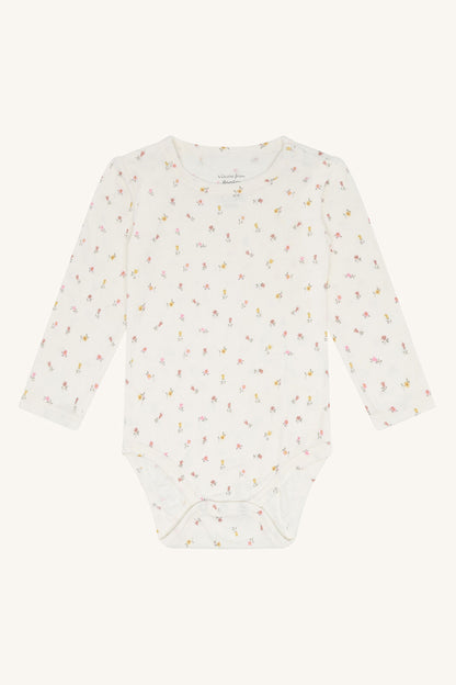 Hust & Claire Buller Bambus Body in Weiss mit Blumenmuster für Babys bei Bärechind in Winterthur, Zürich, Schweiz.