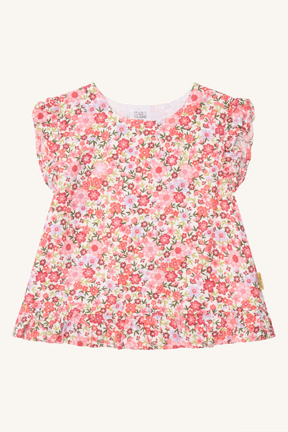 Hust & Claire Roselyn Kinderbluse mit buntem Blumenmuster in Rosa und Pink, V-Ausschnitt und Rüschen an den Schultern, Bärechind Winterthur.
