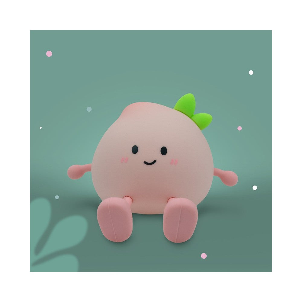 LED Nachtlicht in Form eines Pfirsichs aus Silikon, leuchtend im Kinderzimmer, erhältlich im Bärechind Winterthur Zürich Schweiz.