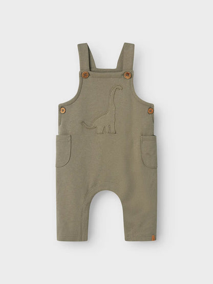 Latzhose von Lil' Atelier mit Dino-Stickerei aus Bio-Baumwolle – erhältlich bei Bärechind Winterthur.