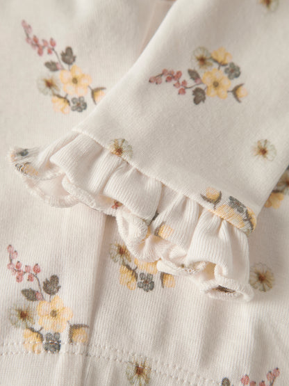 Detail der Lil’Atelier Baby Leggings mit floralem Print und Rüschen am Beinabschluss
