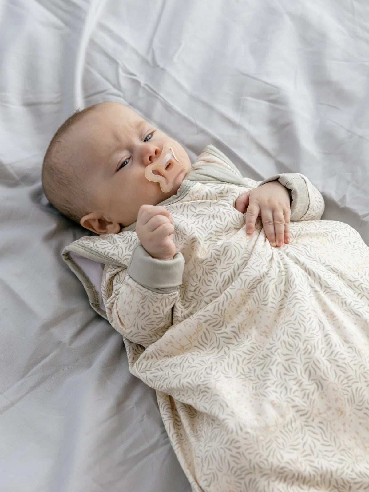Baby schläft im weichen LiluLila Bambus Schlafsack mit verspieltem Löwenmuster. Nachhaltig, hypoallergen und atmungsaktiv – ideal für empfindliche Haut zu kaufen in Winterthur, Zürich, Schweiz.