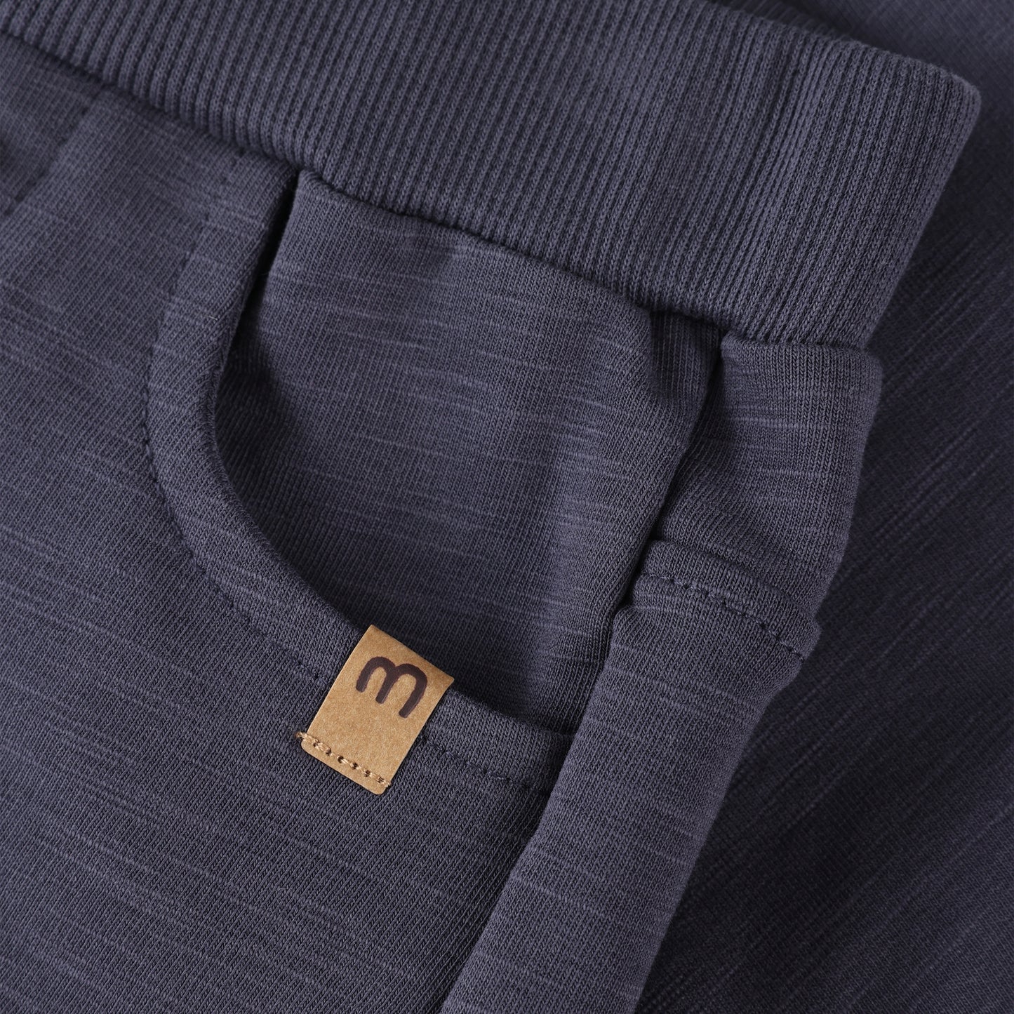 Detailaufnahme Bund und Label der Minymo Sweat Hose aus Bio-Baumwolle bei Bärechind Winterthur, Zürich, Schweiz