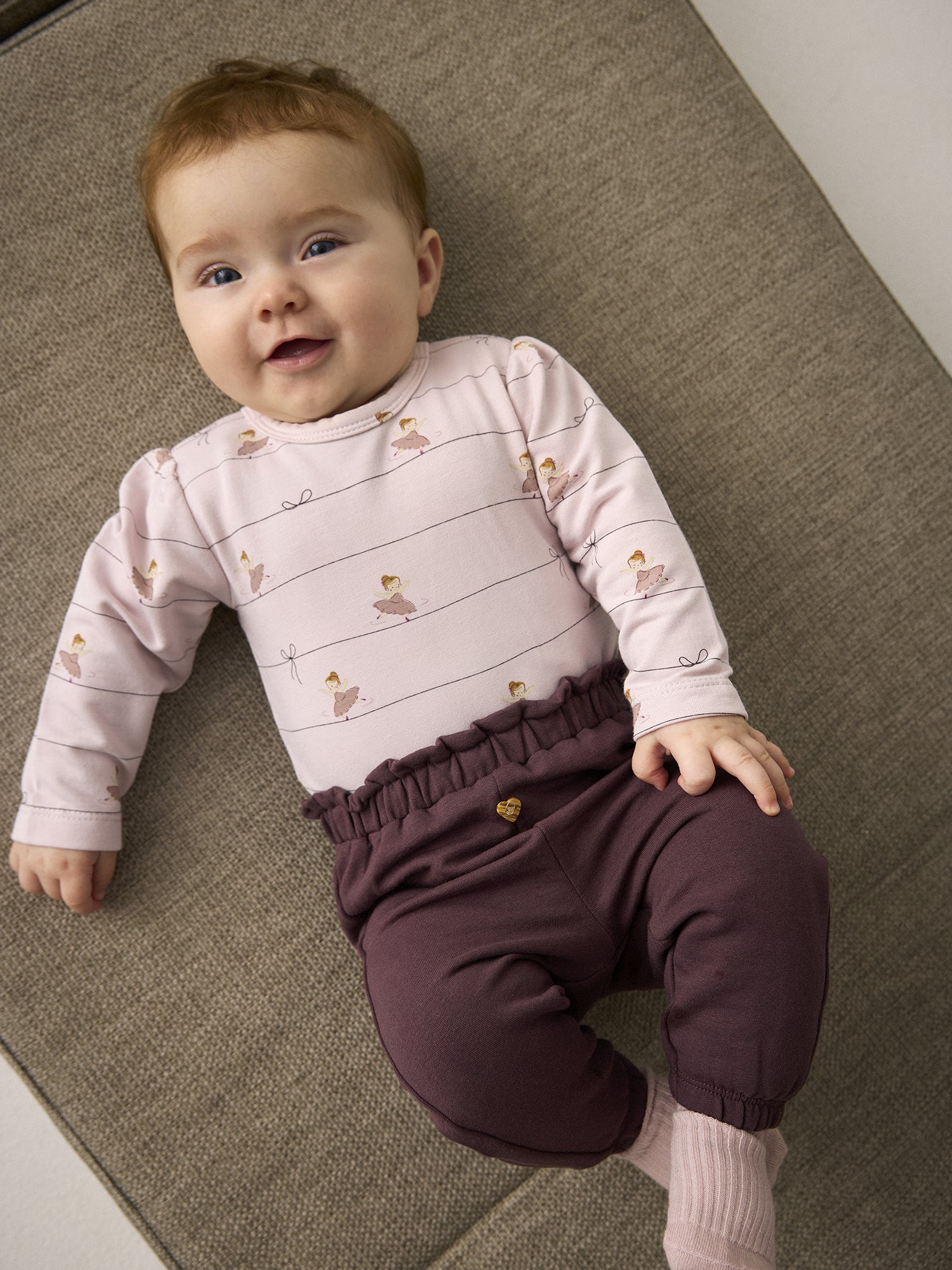 Baby trägt Minymo Sweathose in Huckleberry