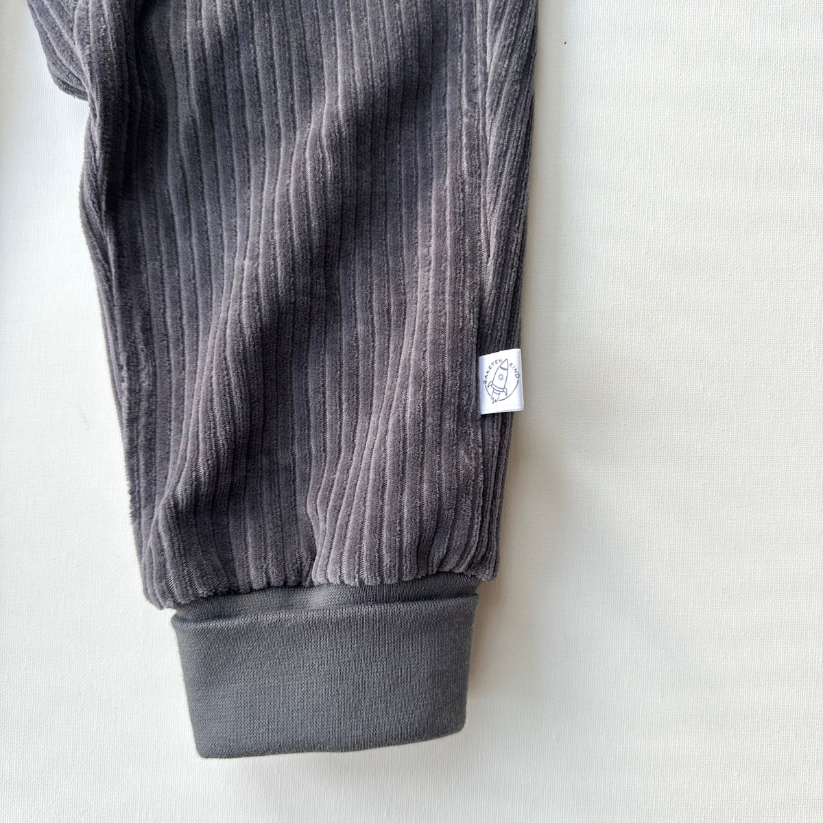 Beinbündchen der dunkelgrauen Raketenkind Cordnicky Hose aus Bio Baumwolle, hergestellt in Winterthur, Bärechind, Zürich, Schweiz.