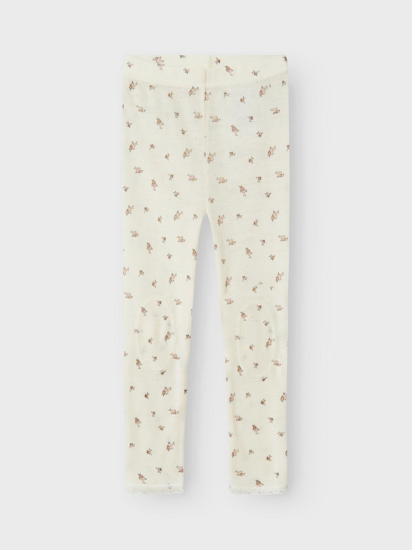 Weisse Wollleggings mit kleinem Blumenmuster aus Merinowolle, flachliegend