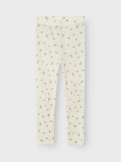 Weisse Wollleggings mit kleinem Blumenmuster aus Merinowolle, flachliegend