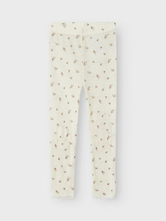 Weisse Wollleggings mit kleinem Blumenmuster aus Merinowolle, flachliegend